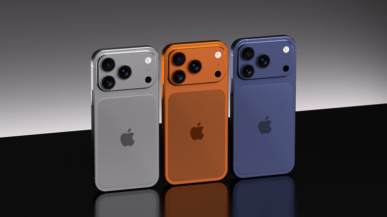 A set of silver, orange, and blue iPhones lined up with their screens facing away from the camera