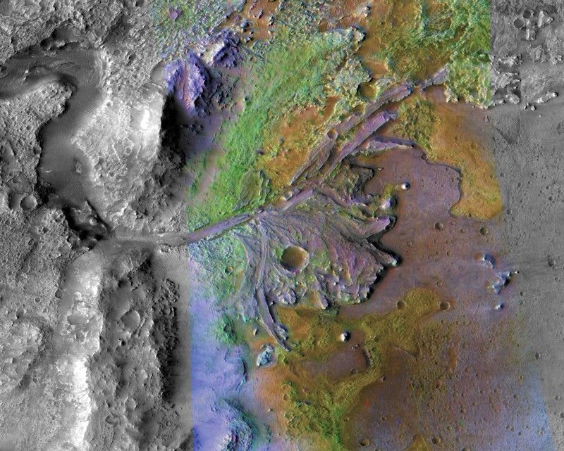 False color image of a crater wall with river delta deposits spreading into the crater from it.