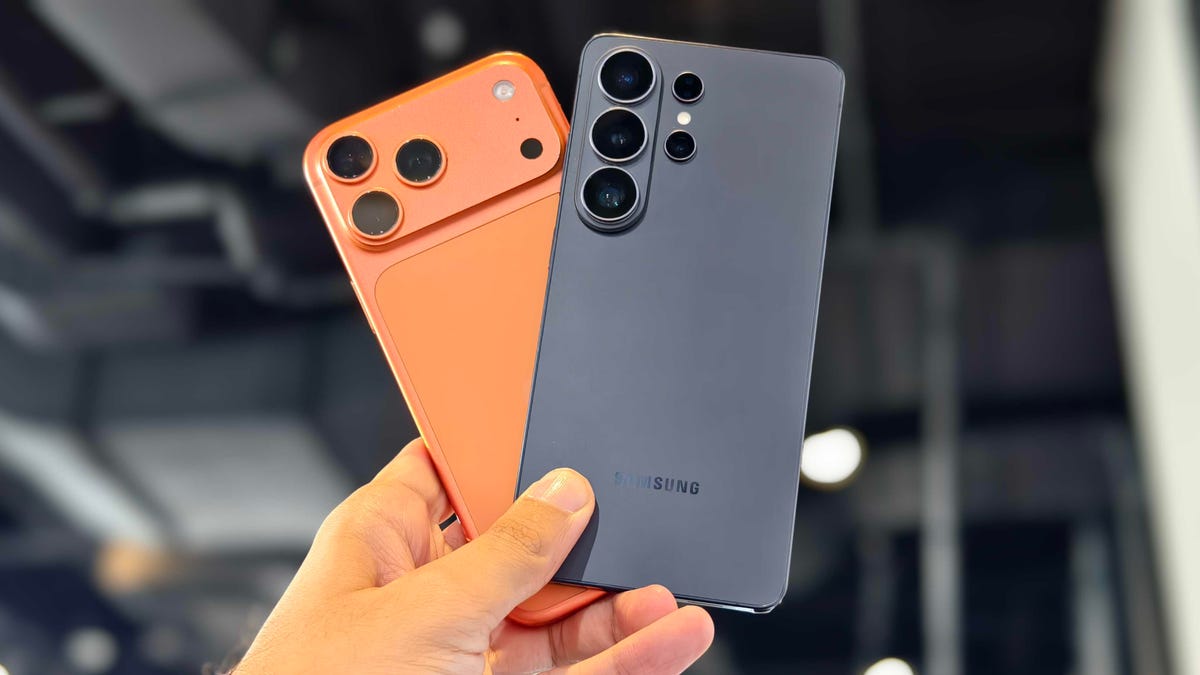 Prakhar holding the iPhone 17 Pro Max and Galaxy S26 Ultra.