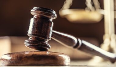A judge's gavel with scales in the background.
