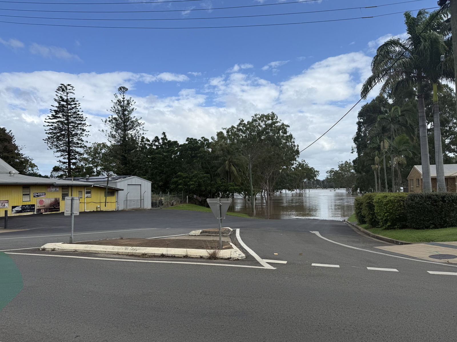 Flood water rising towards a residential street. 