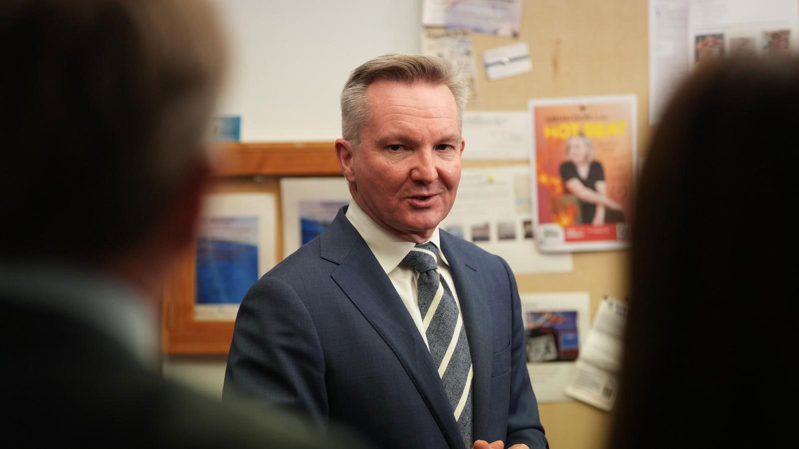 Chris Bowen looks at reporters as he answers questions.
