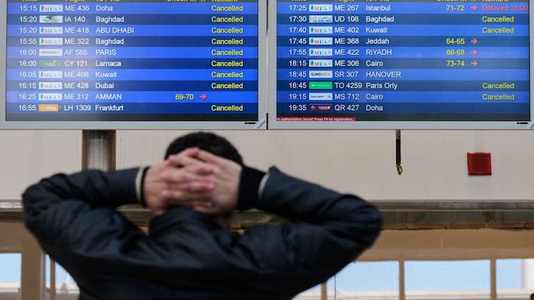 A traveler checks departure times as many flights are cancelled at Beirut Rafik Hariri International Airport in Beirut