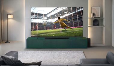 Wall mounted Samsung TV with a soccer player kicking a ball