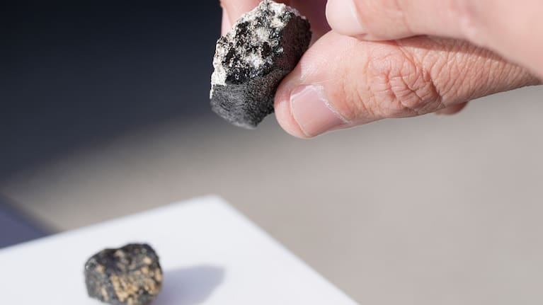 Meteorite hunter Roberto Vargas, of Connecticut, displays one of the meteorites he found in Sharon Center, Ohio, Thursday, March 19, 2026, after a meteor crashed March 17.