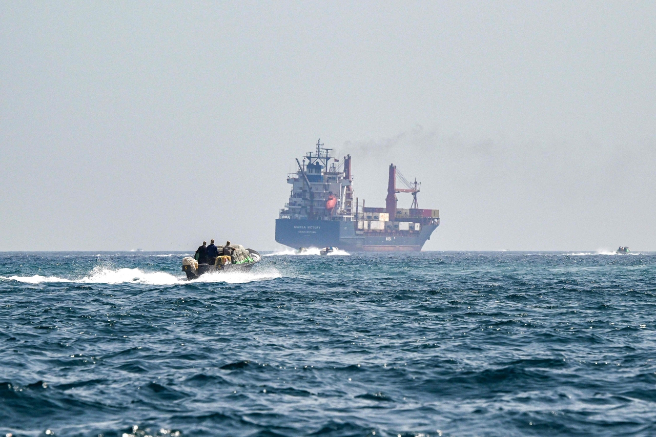 A boat approaches the St Kitt's and Nevis-flagged container ship Marsa Victory while cruising in the waters of the Strait of Hormuz off the coast of Khasab in Oman's northern Musandam peninsula on June 25, 2025.  (File Photo - AFP)