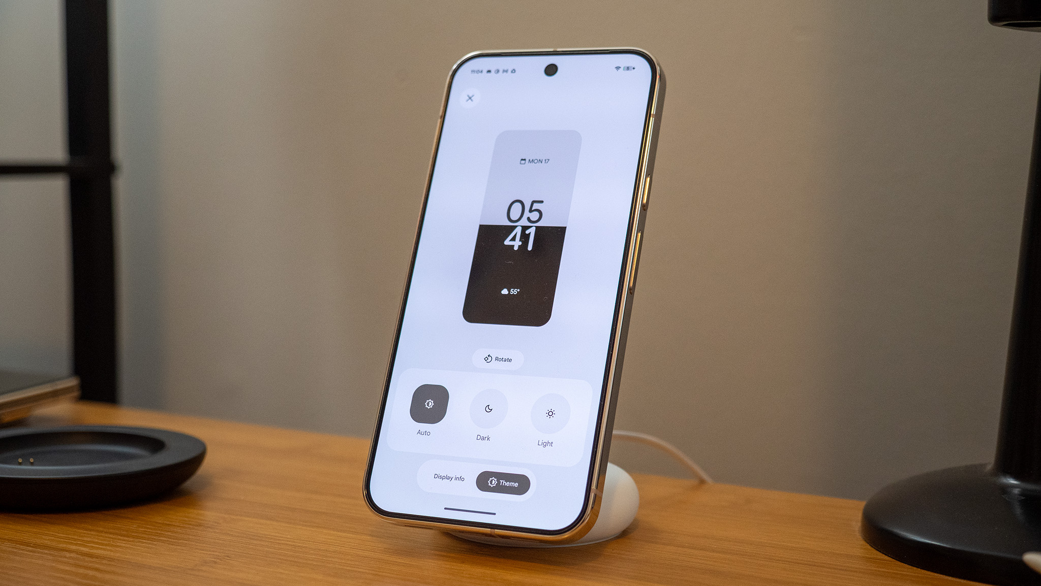 A Google Pixel 10 Pro XL on a Pixelsnap wireless charger with the screensaver function activated