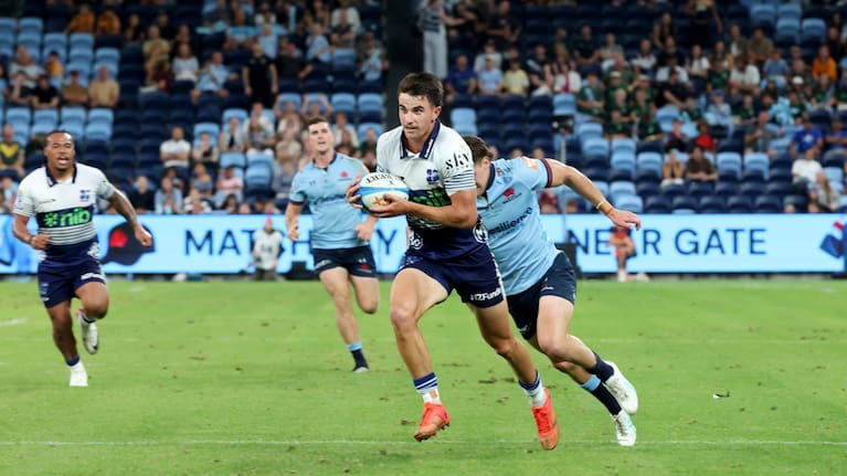 Payton Spencer makes a break on his debut for the Blues against the Waratahs in Sydney.