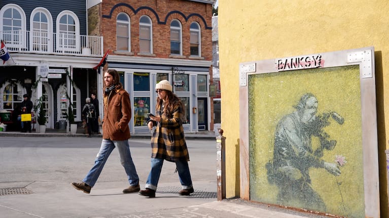 People walk past the Banksy street art piece "Cameraman and Flower" on the opening day of the 2026 Sundance Film Festival on Thursday, Jan. 22, 2025 in Park City, Utah.