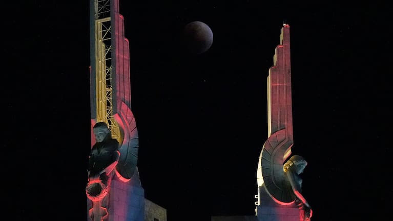 A total lunar eclipse is seen through statues at the Quezon Memorial Shrine in Quezon City, Philippines, Tuesday, March 3, 2026.