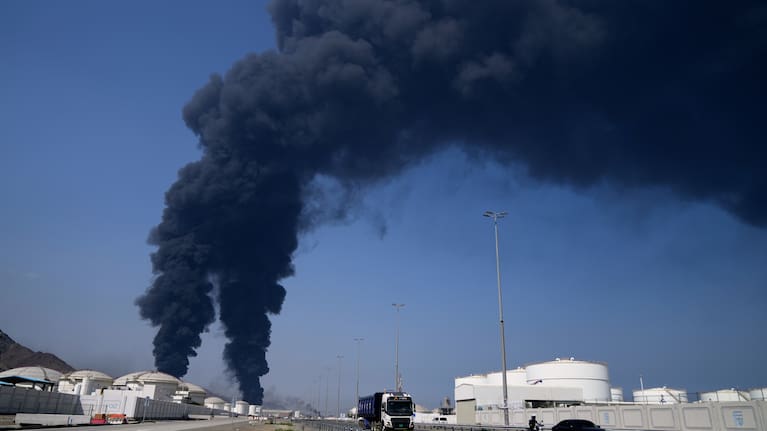 Plumes of smoke rise after debris from an intercepted Iranian drone struck an oil facility, according to authorities, in Fujairah, United Arab Emirates, Saturday, March 14, 2026. 