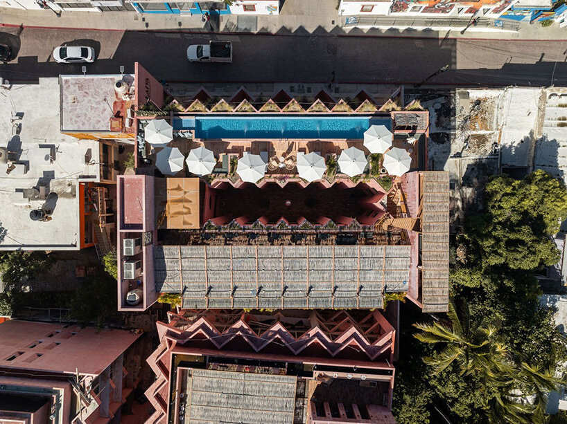 red-toned stucco surfaces form layered facade for boutique hotel by RA! in mexico - 9