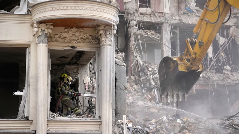 Rescue workers and first responders work at a residential building hit in an earlier US-Israeli strike in Tehran, Iran.
