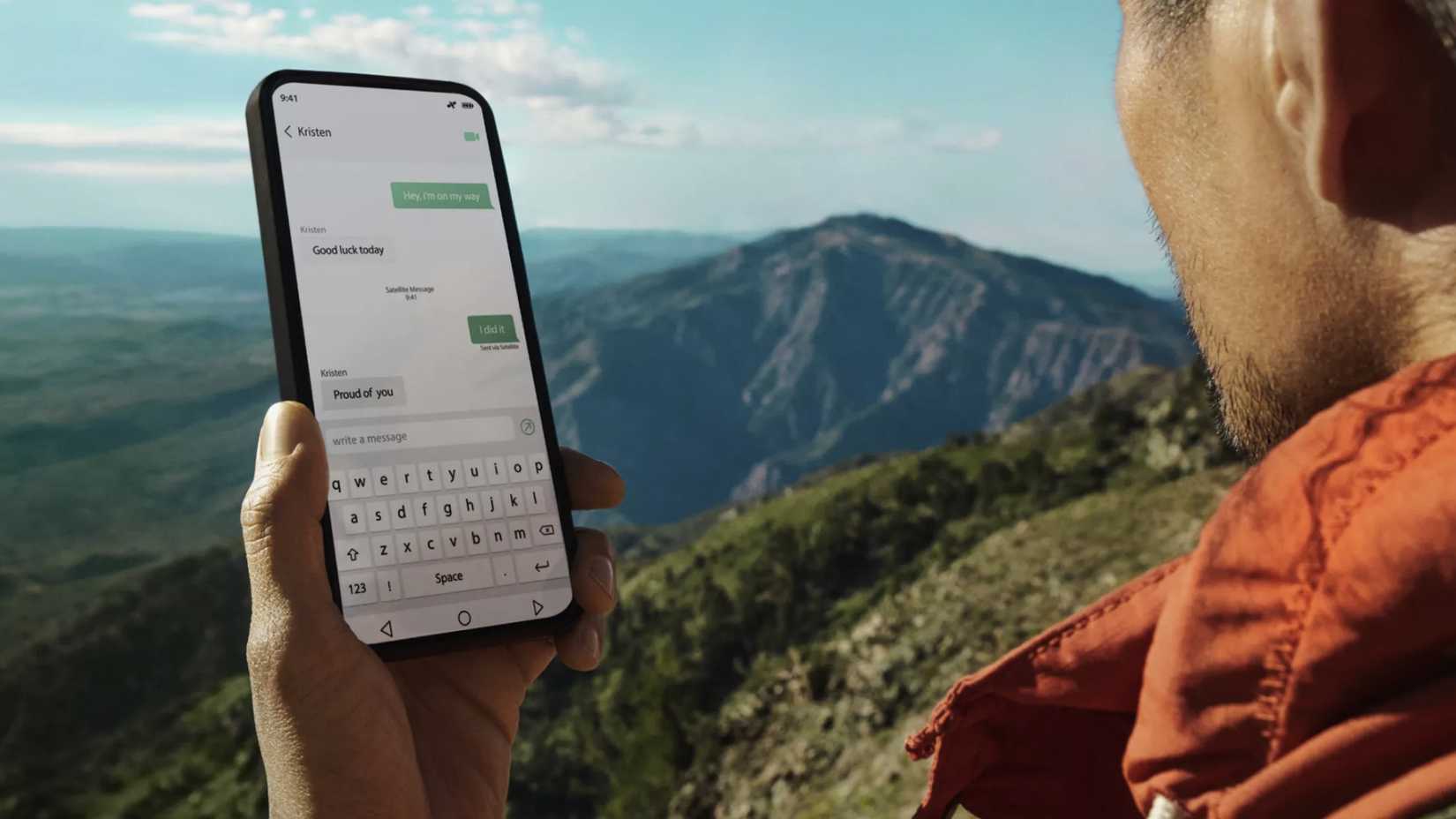 A person hiking holding a phone in hand using satellite SMS messaging.