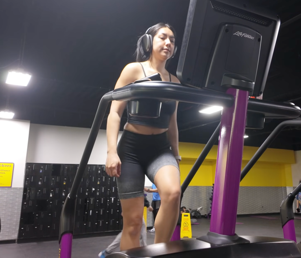 a person exercising on a stair climber machine in a gym