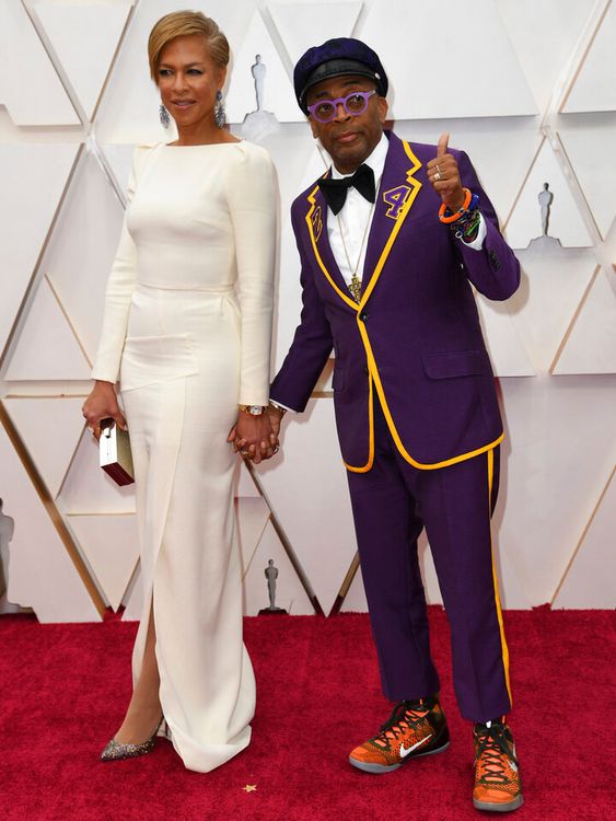 Spike Lee wearing a gold and purple jacket in honour of late basketball player Kobe Bryant in 2020. Pictured with his wife Tonya Lewis Lee. Pic: AP