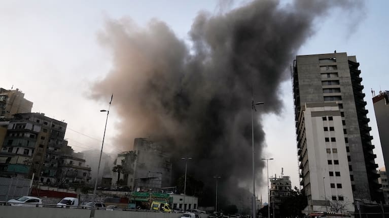 Smoke rises from a building targeted by an Israeli strike in central Beirut, Lebanon, Thursday, March 12, 2026.