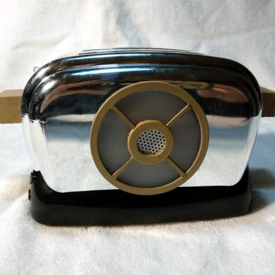 A chrome toaster with a 3D printed speaker grille in the manner of the Red Dwarf prop.