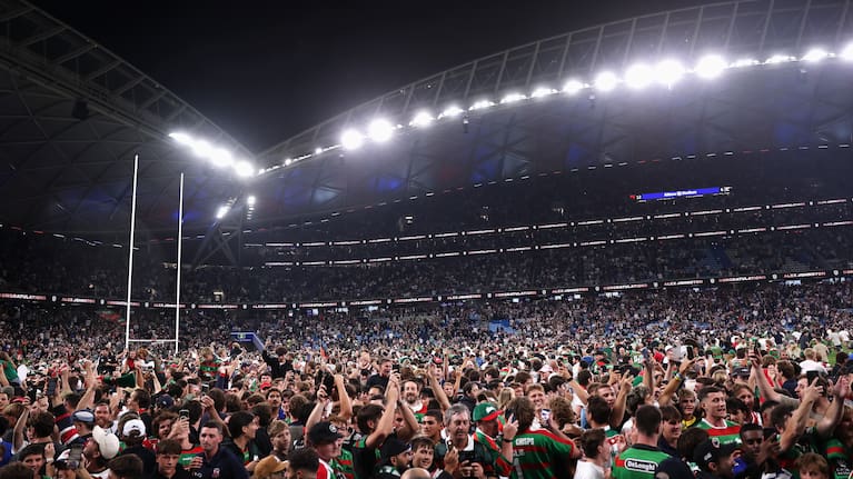 Thousands of fans have stormed onto the field at Sydney's Allianz Stadium to celebrate Alex Johnston's record-breaking 213th NRL try.