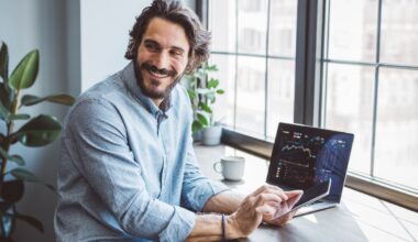 An investor sits at a desk and smiles.