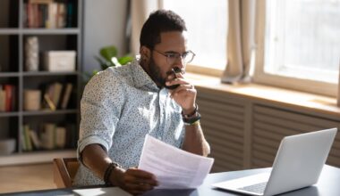 An investor studies something on a laptop.
