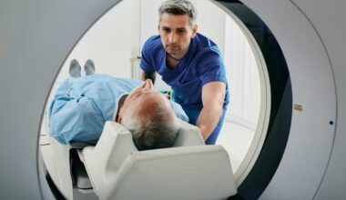 Medical professional assisting a person in an MRI machine.