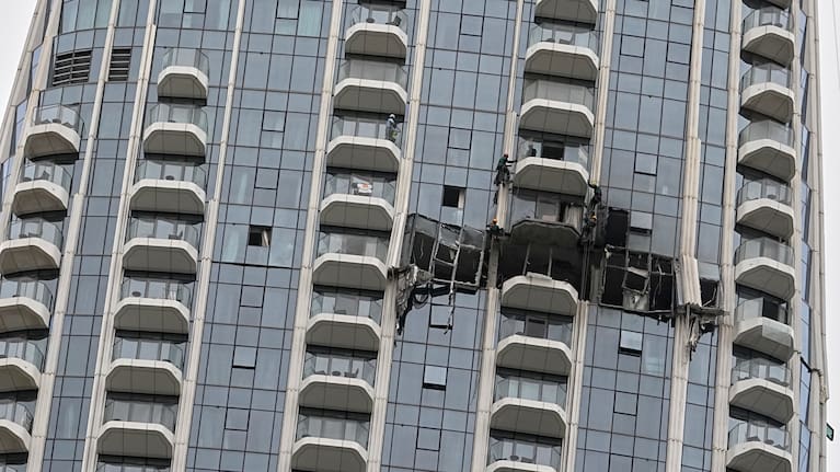 Workers inspect damage caused by a drone strike overnight at the Address Creek Harbour hotel in Dubai, United Arab Emirates, March 12, 2026.