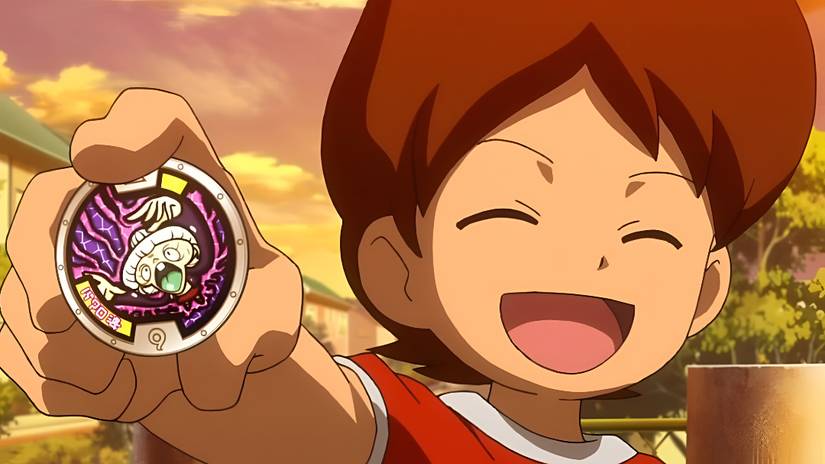 A redheaded kid holds up an elemental stone and laughs in Yo-Kai Watch
