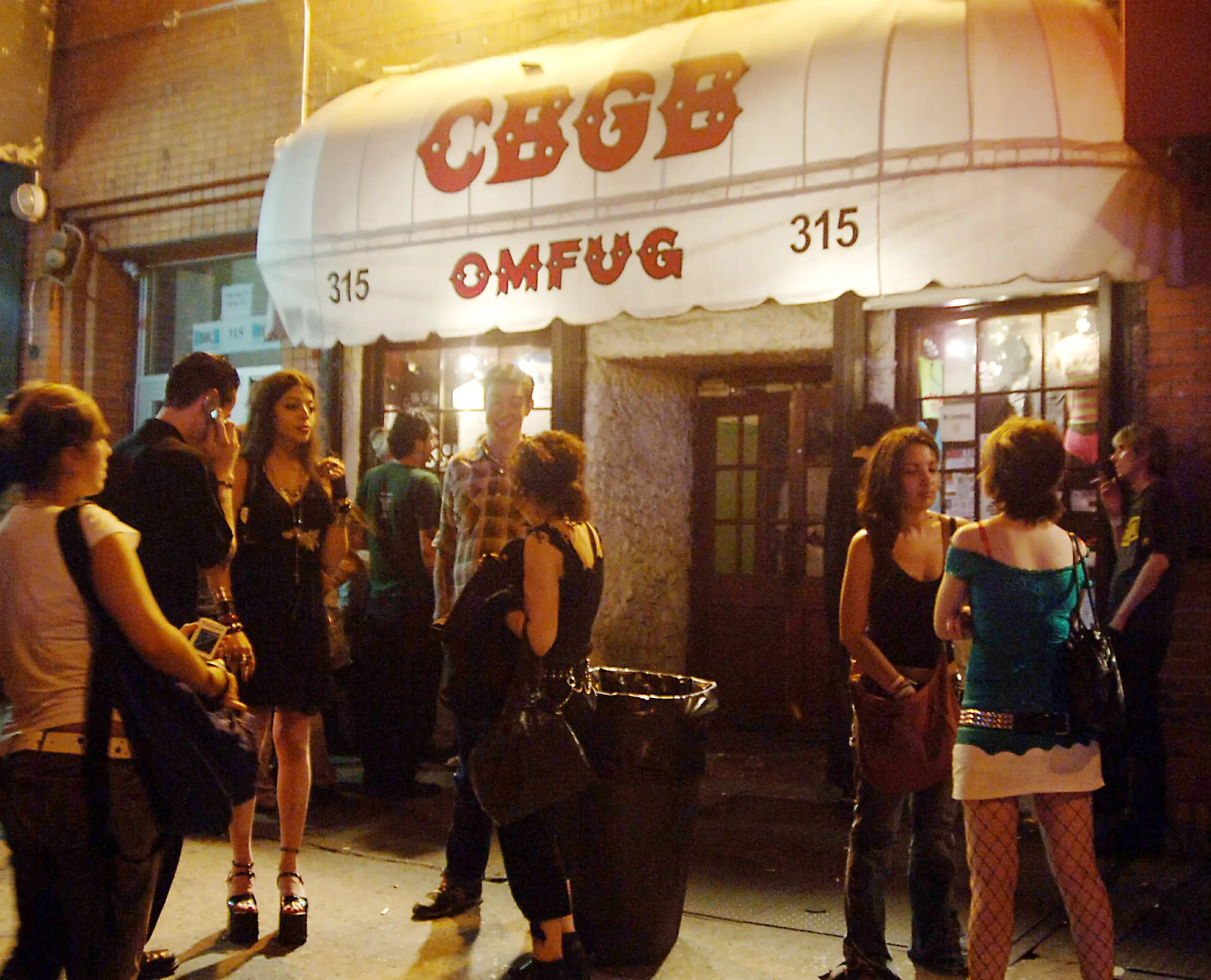 Fans stand outside the CBGB rock and roll nightclub in New York City.
