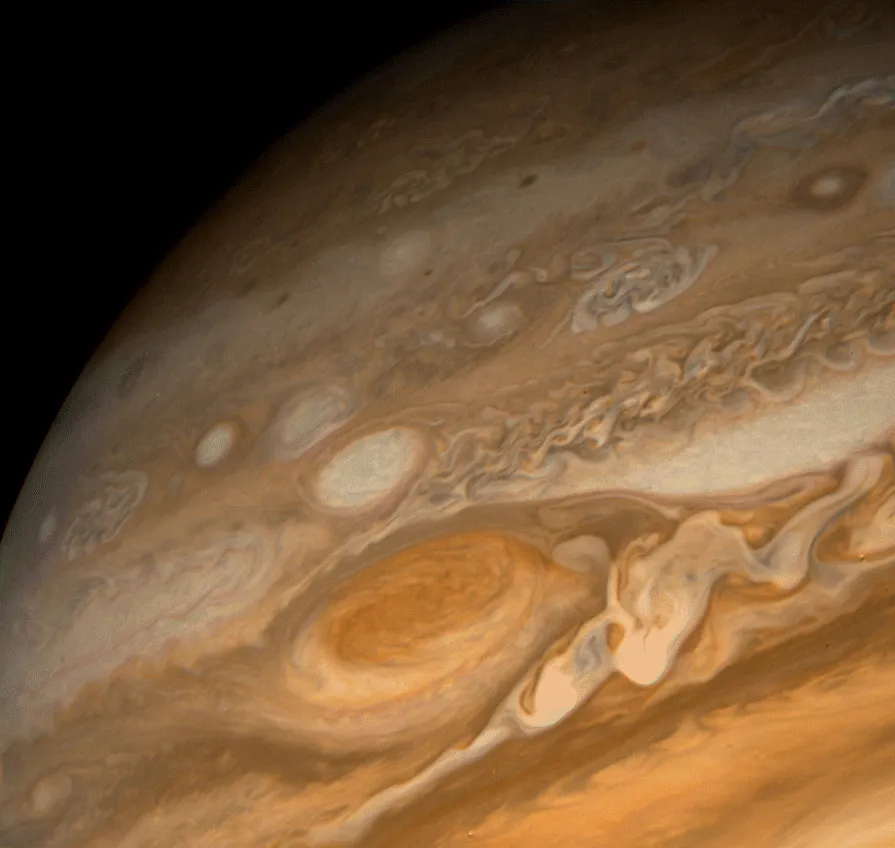 Jupiter's Great Red Spot captured by Voyager 1 in February 1979, at a distance of 9.2 million km. The wavy cloud pattern to the right of the Red Spot is variable wave motion in the atmosphere; evidence of large-scale storms. (Credit: NASA/JPL)