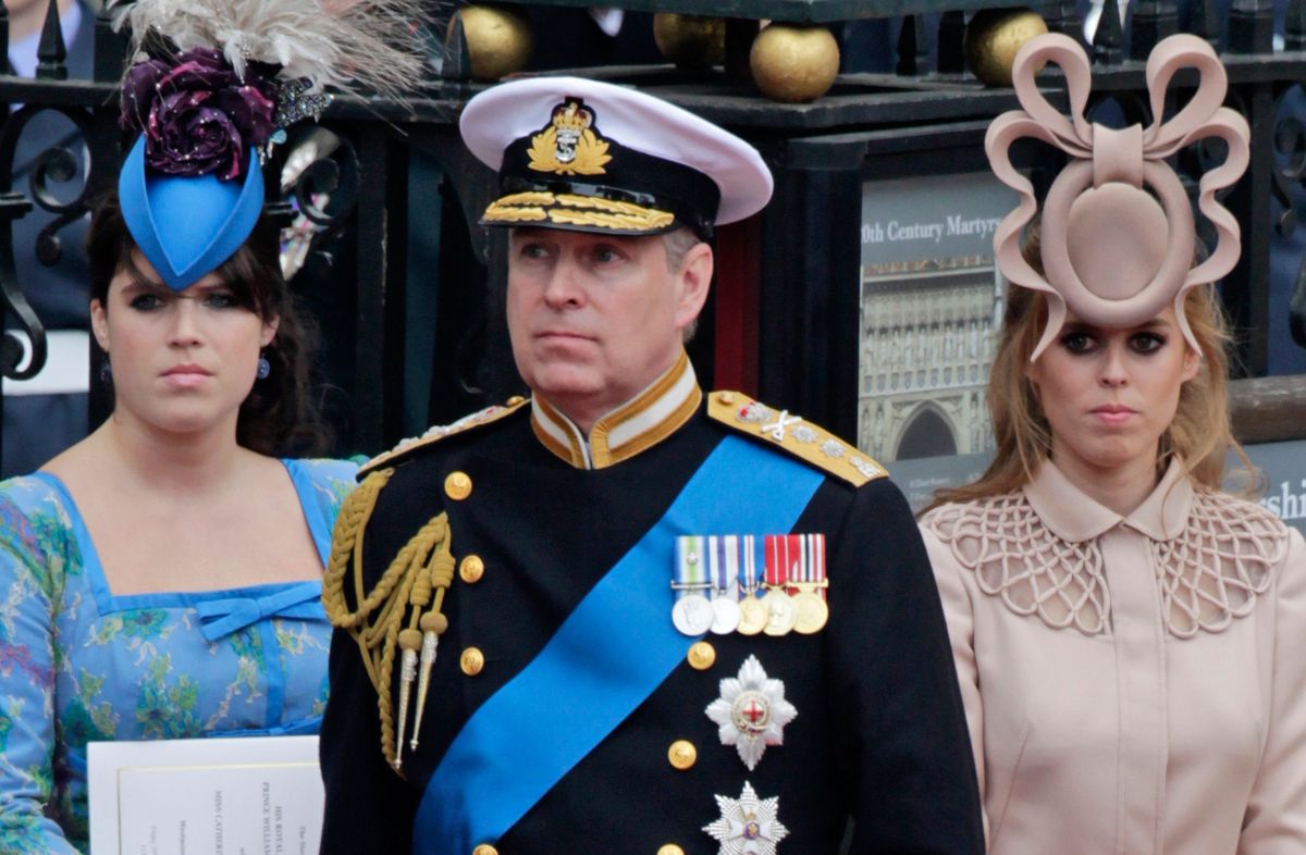 Andrew, center, and his daughters Princess Eugenie, left, and Princess Beatrice leave Westminster Abbey after the wedding of Prince William to Catherine Middleton