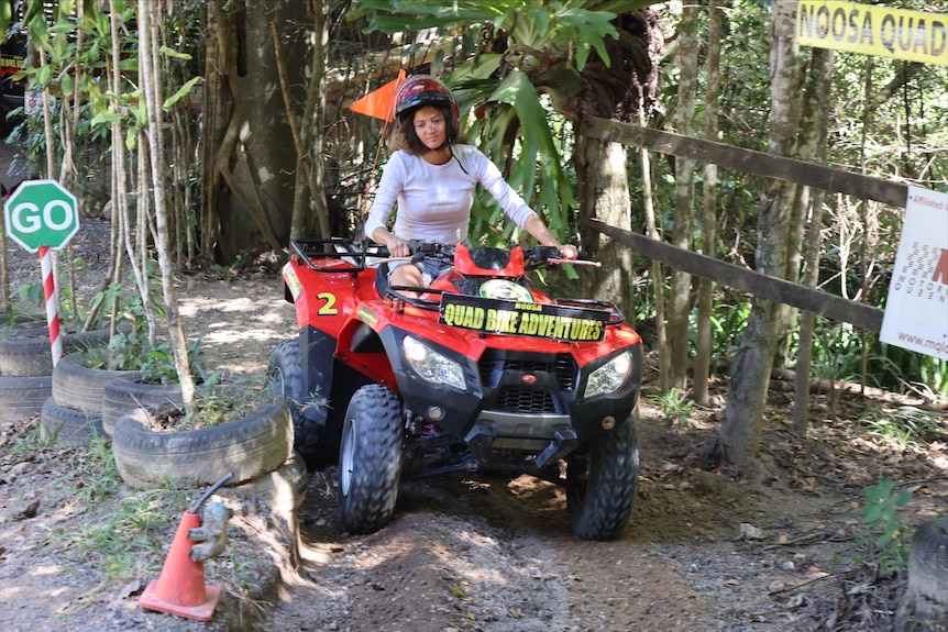 A woman riding a quad bike
