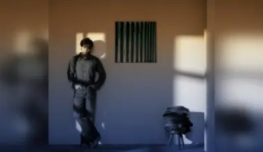 BTS' RM posing with Yun Hyong-keun’s Blue (1972) on the wall.