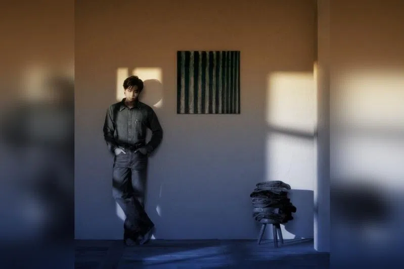 BTS' RM posing with Yun Hyong-keun’s Blue (1972) on the wall.