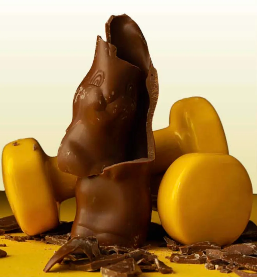 Photo of a broken chocolate with weights behind it