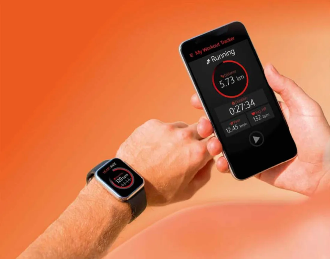 Close up photo of a person's hands. On the left hand is a smart watch with heart rate listed and in the right hand is a smartphone with running distance and time listed