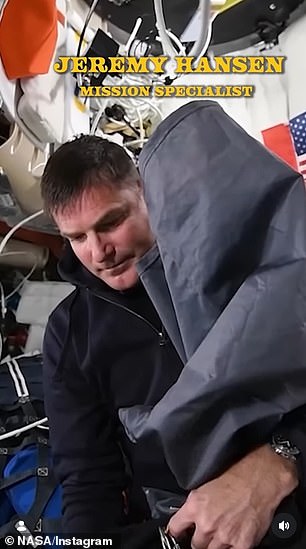 Mission specialist #2 Jeremy Hansen busied himself with a nylon tarp, not looking at the camera