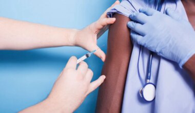 A photo of a female healthcare worker getting vaccinated.