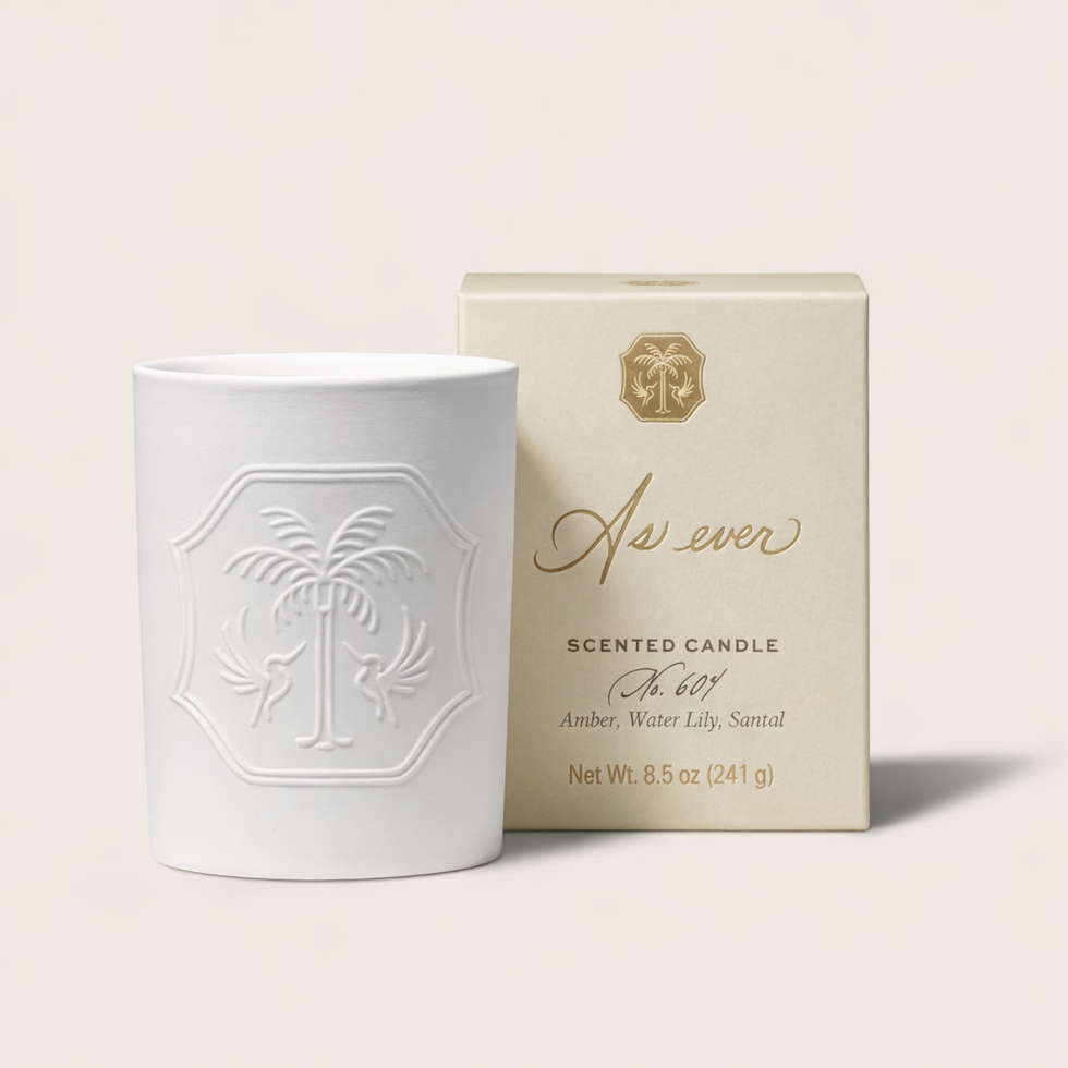 Scented candle with decorative packaging.