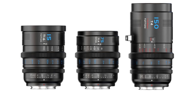 Three black camera lenses of varying heights are displayed upright in a row against a white background. Each lens has blue and white markings, with focal lengths labeled 15mm, 75mm, and 150mm, along with detailed focus and aperture scales.