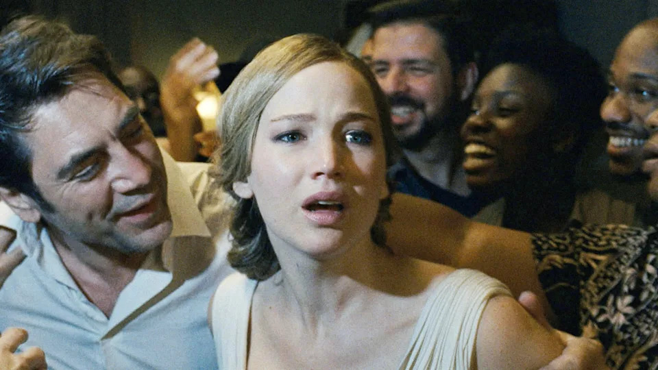 A woman appears distressed in a crowd of smiling people at a gathering. The atmosphere contrasts her anxious expression