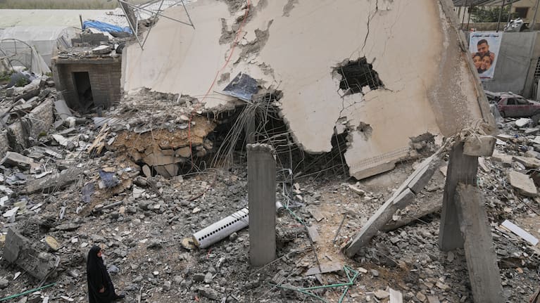 A woman checks a destroyed house that was hit in an Israeli airstrike in Saksakiyeh village, south Lebanon, Friday, April 3, 2026.