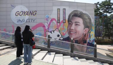 Fans take a look at a mural of BTS