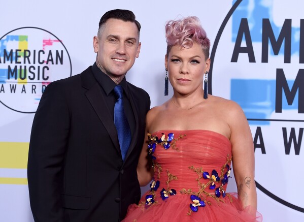 Singer Pink, right, and Carey Hart appear at the American Music Awards in Los Angeles on Nov. 19, 2017. (Photo by Jordan Strauss/Invision/AP, File)