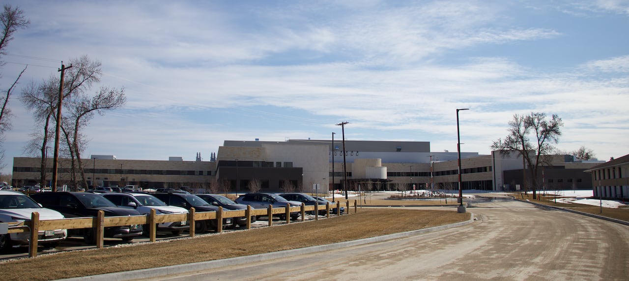 Roadways lead toward a parking lot and hospital lot.