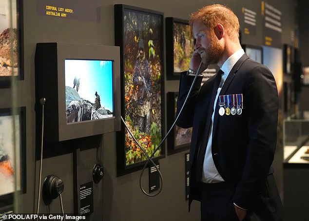 Britain's Prince Harry, the Duke of Sussex, engages with an interactive display in the Anzac Hall during a visit to the Australian War Memorial in Canberra on April 15, 2026. (Photo by Jonathan Brady / POOL / AFP via Getty Images)