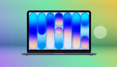 Black Apple Macbook Neo against purple, blue, green and yellow CNET background.