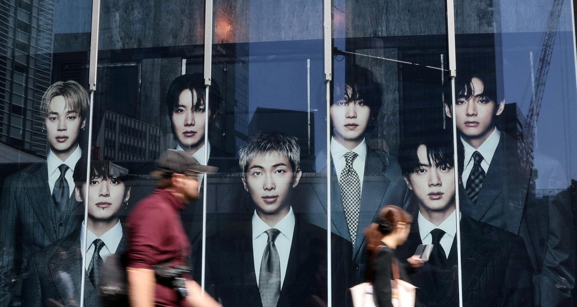 Passerby walks past a pop-up store of K-pop boy band BTS ahead of the band