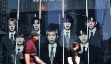 Passerby walks past a pop-up store of K-pop boy band BTS ahead of the band