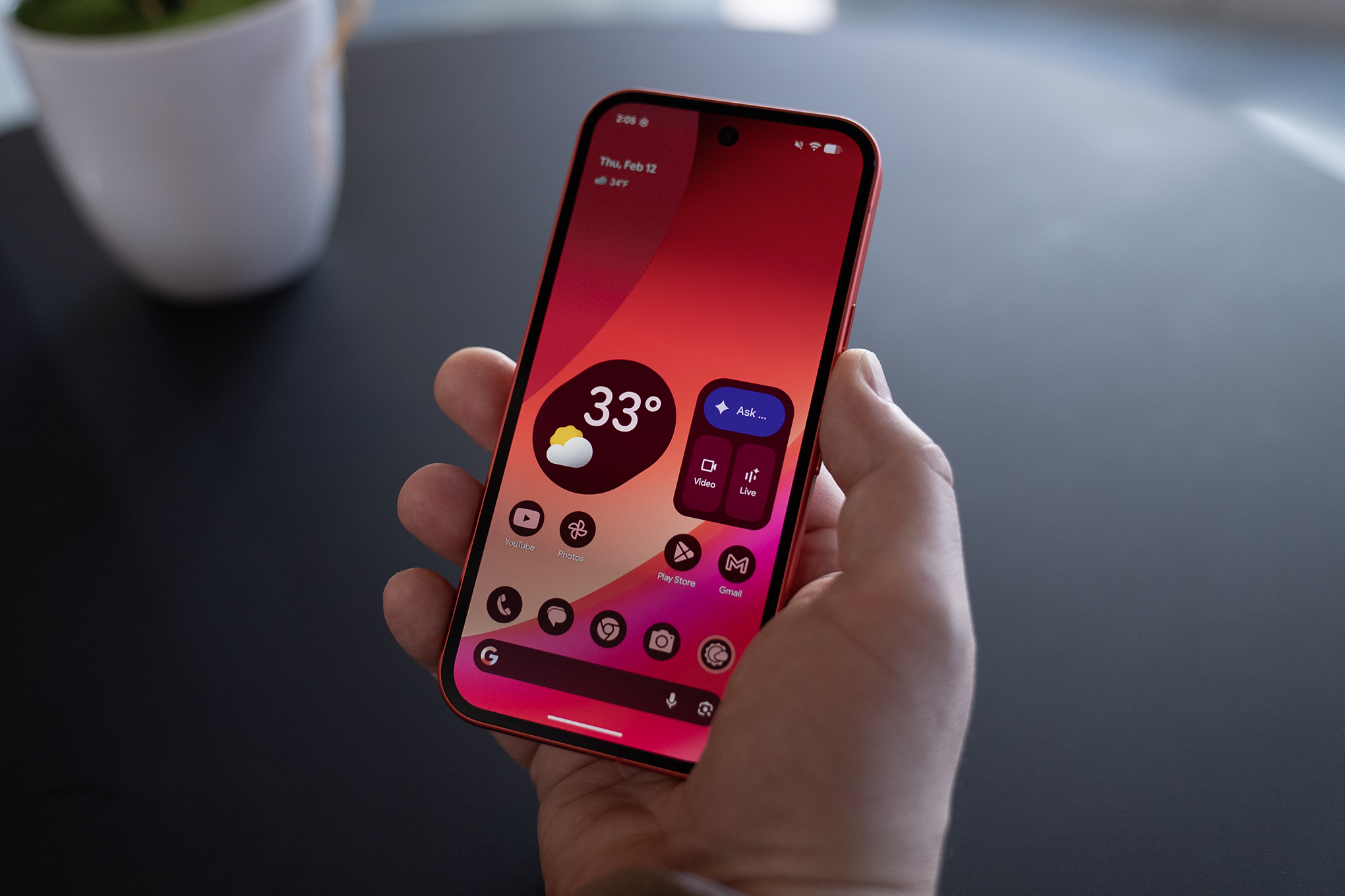 Illuminated screen of a Google Pixel 10A in someone’s hand.